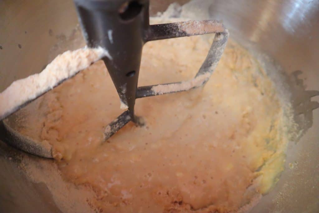 one cup of flour added to bread dough
