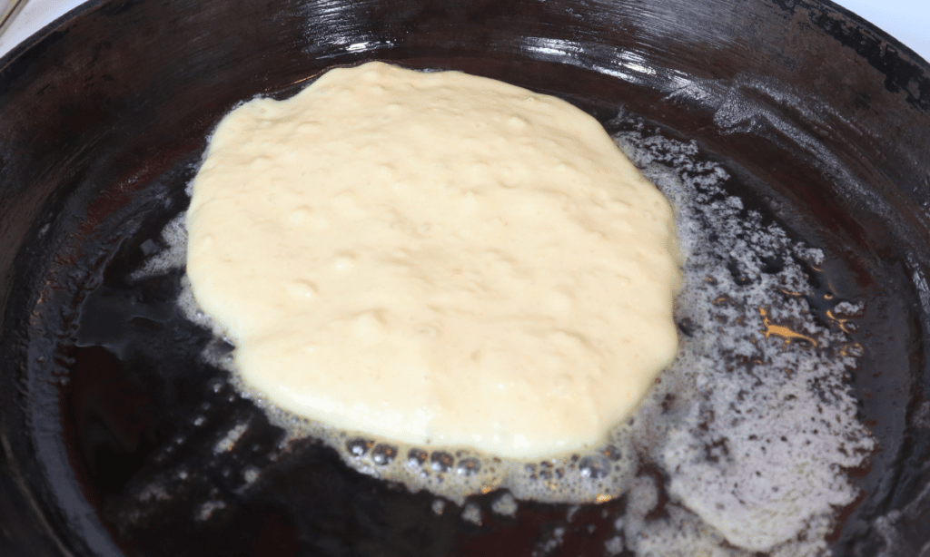 pancake batter in cast iron skillet