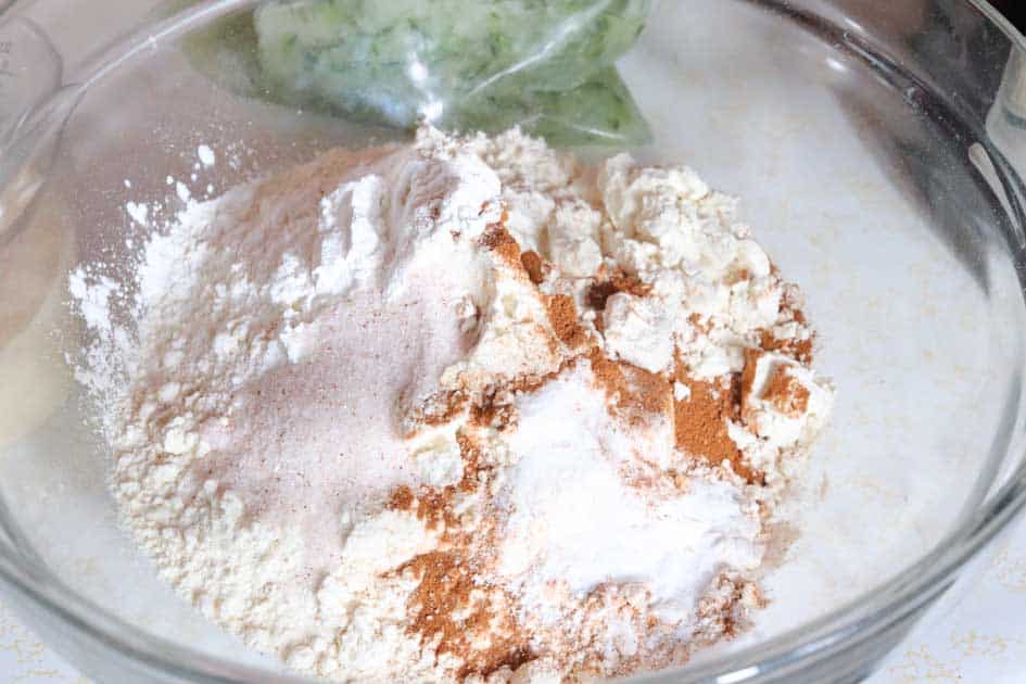 sourdough discard zucchini muffin dry ingredients in glass bowl