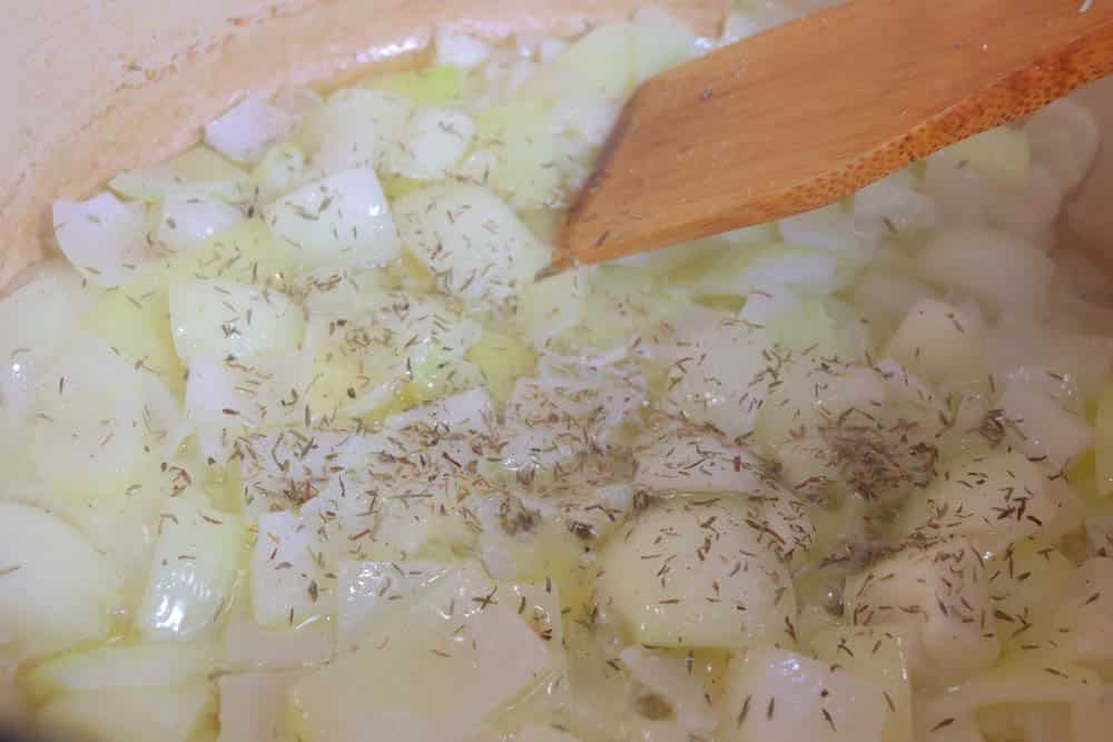 adding seasonings to softened onions
