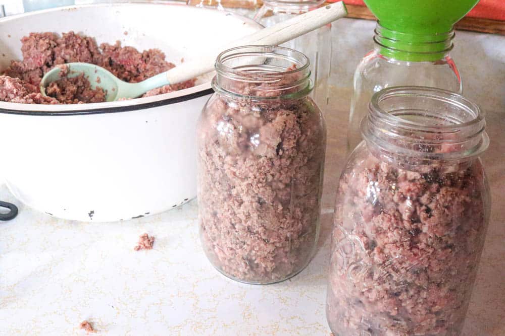 filling mason jars with ground beef