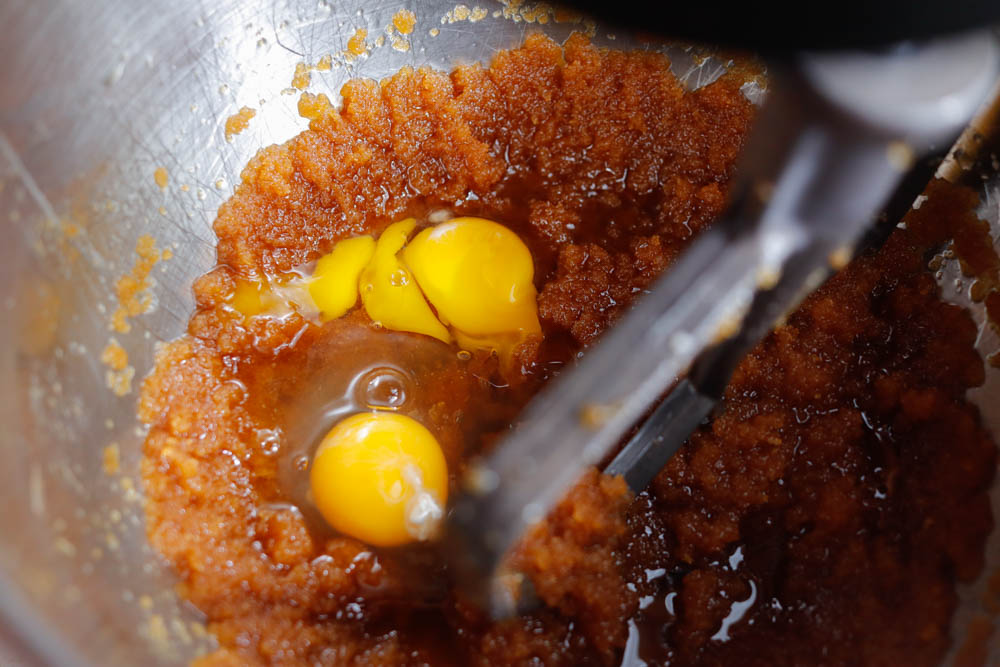 adding eggs in butter and sugars